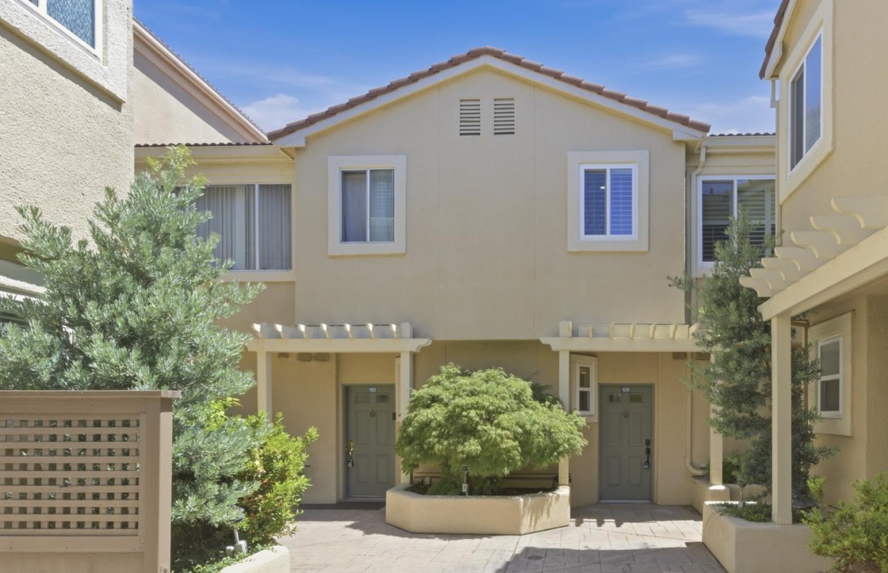 Front elevation of 88 17th Ave #109, a two-story Mediterranean-style townhome with a tile roof and trellised entry in central San Mateo